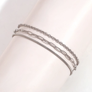 Three-layer silver stainless steel anklet with snake and oval link chain on white display