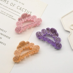 Three elegant hollow hair claws with rhinestones in pink, purple, and orange colors