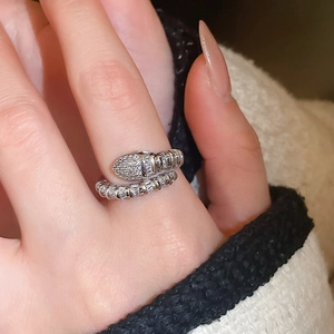 Close-up of silver snake ring with cubic zirconia scales in a wrap-around open design