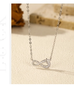 Detailed macro shot of an S925 silver infinity pendant set with sparkling zircons