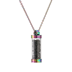 Detail of rainbow stainless steel perfume bottle pendant filled with black crystals