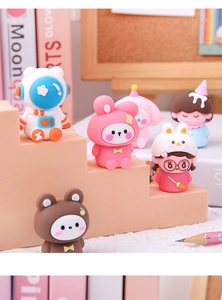 Close-up of cute astronaut and animal pencil sharpener figures on a display stand