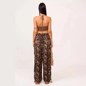 Loose leopard print cargo trousers and backless halter top shown from the back view