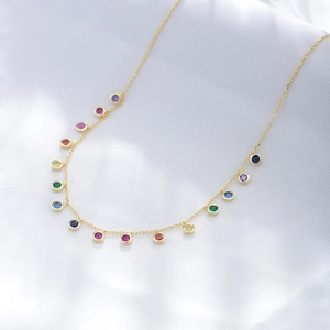 Elegant gold S925 silver necklace featuring colorful round zircon rainbow pendants on fabric