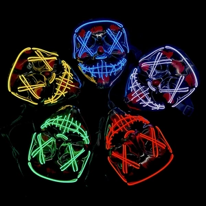 Detail of five colorful LED Halloween masks with glowing EL wires in dark background