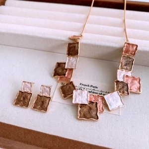 Detail view of vintage square enamel pendant and earrings set in a premium jewelry box
