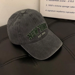 Detailed close-up of vintage charcoal wash baseball cap with green New York embroidery