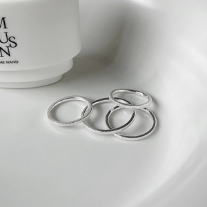 Detailed macro view of S925 sterling silver rings showing ribbed texture and hallmark
