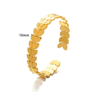 Detail showing 10mm wide gold stainless steel open bangle with hollow leaf texture
