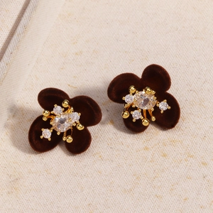 Macro shot of geometric flower stud earrings with brown velvet petals and zircon center