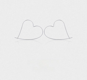 Detailed close-up of minimalist sterling silver heart hoop earrings with slim wire design