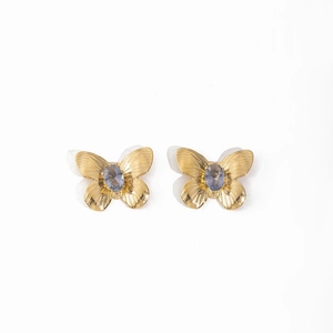 Detail of 18K gold butterfly earrings with lavender oval gemstones on a white background