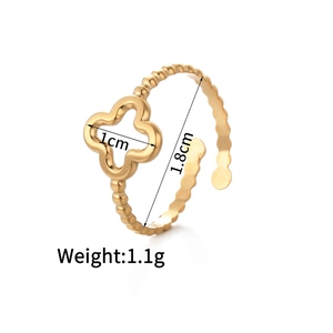 Detail of 14K gold open ring featuring a clover charm and beaded texture band