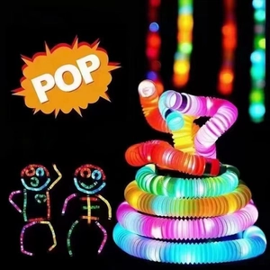 Macro shot of colorful glowing stretch tubes coiled into a creative figure in dark setting