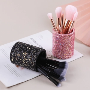 Sparkling pink and black cylindrical makeup brush holders with glitter finish for vanity desk