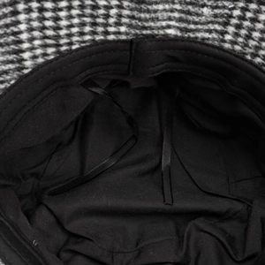 Close-up detail of the black inner lining and adjustable drawstrings of a wool hat