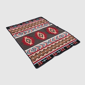 Detail view of Southwestern style flannel blanket featuring ethnic geometric patterns