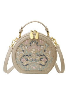 Ethnic embroidery small round shoulder bag in beige with gold-tone hardware on white background