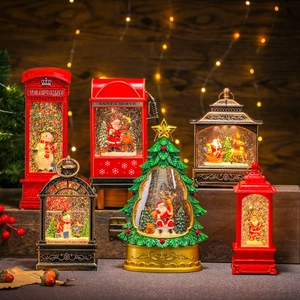 Lighted Christmas lantern ornaments featuring Santa and glitter snow scene decorations