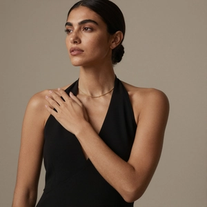 Minimalist 18k gold plated twisted chain necklace shown on a professional model neck