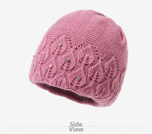 Detailed knit texture of pink mohair beanie with leaf pattern and pearl accents