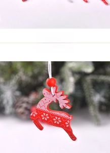 Detail of red wooden reindeer ornament with white snowflakes on festive background