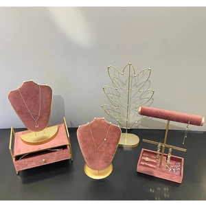 Pink velvet and gold metal jewelry display set with necklace bust and leaf stands