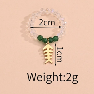 Detail of beaded ring with green accents and gold fishbone pendant showing 2cm inner diameter