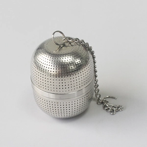 Detailed macro view of 304 stainless steel tea infuser ball with fine mesh and metal chain