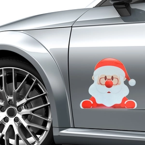 Close-up of reflective Santa car magnet with honeycomb texture on silver vehicle door