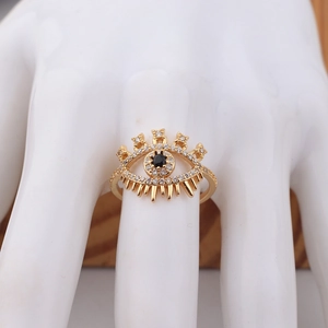 Golden evil eye ring with black and white crystals on a snake shaped band for women