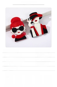 Detail view of vintage acrylic girl brooches in red and black with size parameters