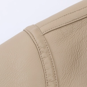 Close-up of premium beige faux shearling jacket showing high-quality leather texture