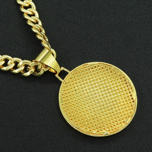 Detail showing the grid texture on the back of a gold Cuban chain necklace pendant