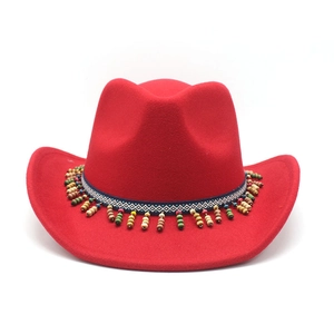 Detail of red wool felt cowboy hat with colorful wooden bead tassels and ethnic ribbon