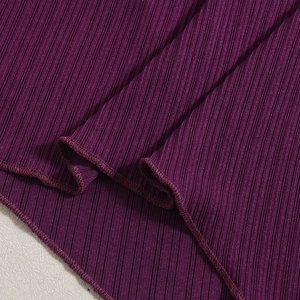 Close-up of purple ribbed knit fabric showing detailed stitching and elastic texture