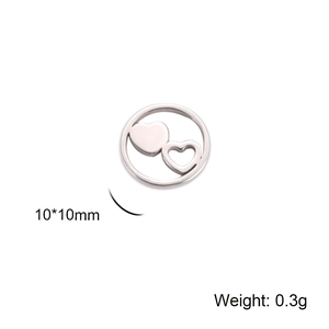 Detail of 10mm silver heart pendant with solid and cutout charms on white background