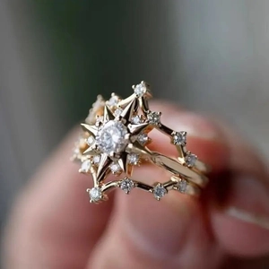 Three-layer gold starburst ring with round zircon center and shimmering pave accents