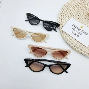 Flat lay of multiple candy-colored triangle cat eye sunglasses in various frame colors