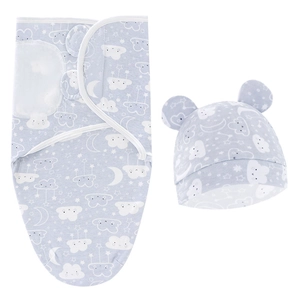 Close-up of light blue newborn swaddle blanket and hat set with cloud and star patterns