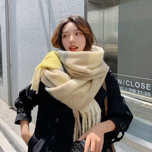 Winter checkered scarf in beige and yellow plaid with long fringes on street model