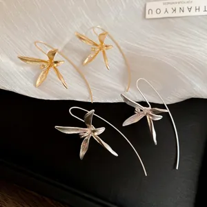 Elegant iris flower drop earrings in gold and silver finish with brushed metal petals