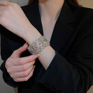 Vue détaillée des motifs floraux ajourés sur un bracelet vintage en métal argenté