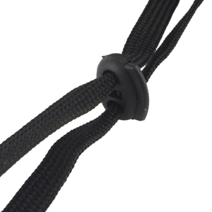 Detailed macro view of adjustable black tactical drawstring cord and plastic stopper toggle
