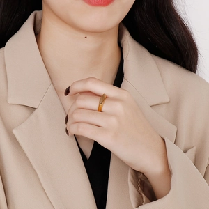 Golden titanium steel ring with a fishnet design shown on a model wearing a suit