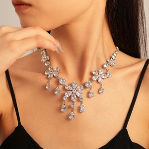 Close-up of sparkling flower zircon necklace with water drop tassel on woman neck