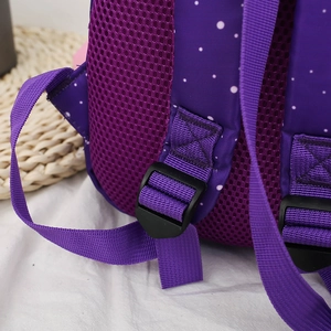 Detail of purple polka dot toddler backpack featuring breathable honeycomb mesh and strap buckle