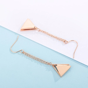 Detail of rose gold geometric triangle earrings with long delicate tassel chains