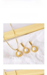 Detailed view of 18k gold plated stainless steel jewelry set with white pearls