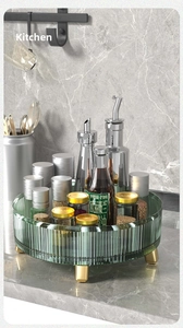 Detail of dark green transparent rotating kitchen tray with gold legs and ribbed texture